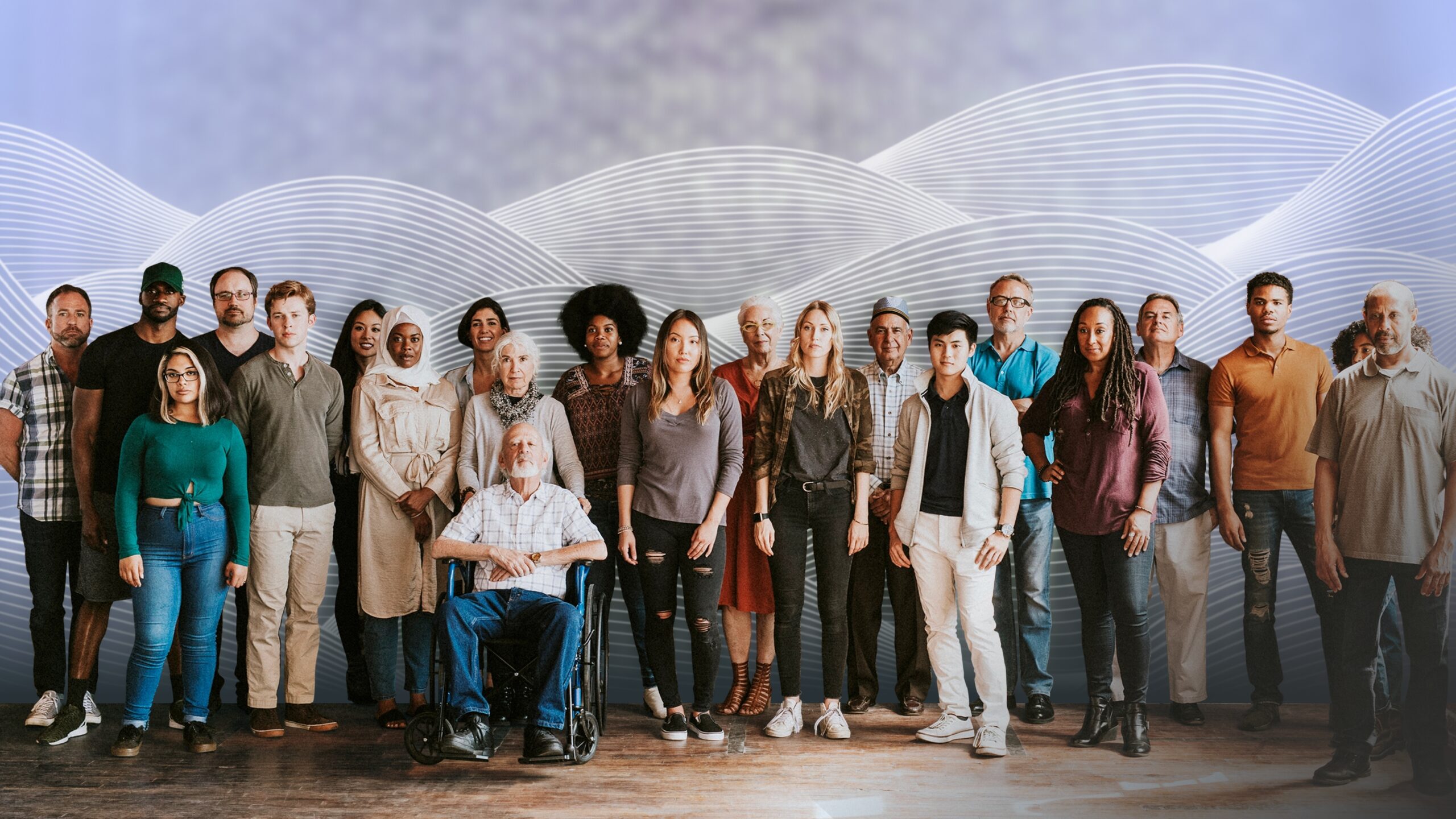 A diverse group of people, including a wheelchair user, standing together in front of a modern blue and grey backdrop, reflecting Ottetto’s commitment to inclusive design and equitable user experiences.